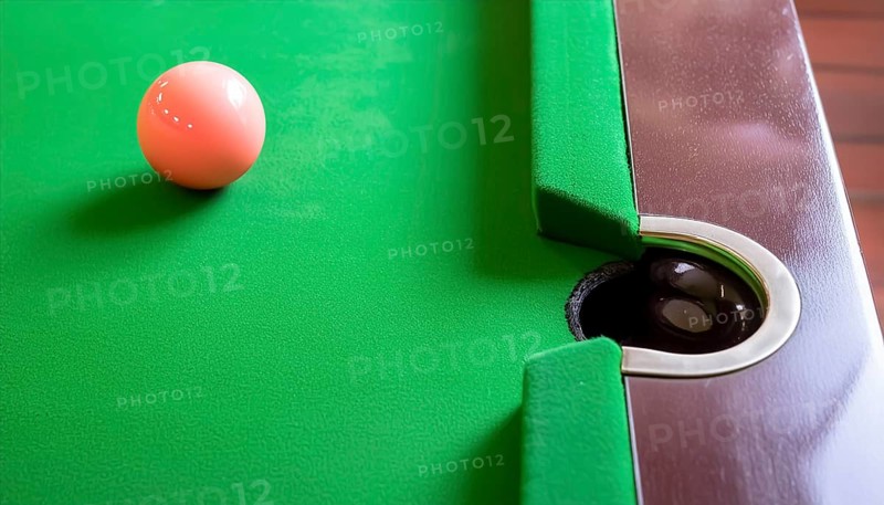 AI generated image showing a billiards table closeup with ball and pocket