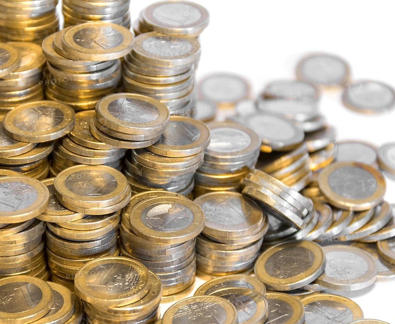 Lots of stacked 1 euro coins