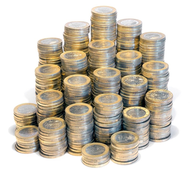 Lots of stacked 1 euro coins in white back