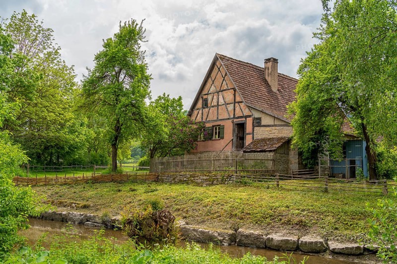 Idyllic scenery with farm house around a rural village in Hohenlohe, an area in Southern Germany at spring time
