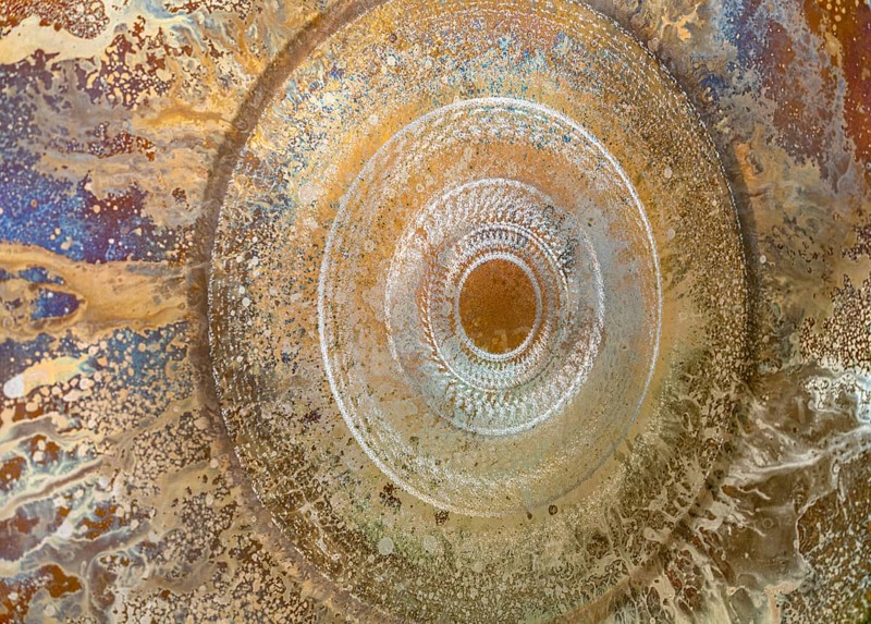Full frame abstract closeup shot of a colorful metallic asian gong