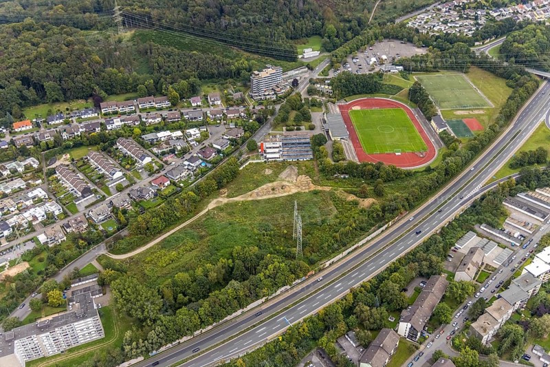 Aerial view, fallow land at the Kirchenbergstadion with planned construction of a fitness centre in the Hohenlimburg district, Hagen, Ruhr area, North Rhine-Westphalia, Germany, A46 motorway, construction area, building site, building plots, construction project, construction site, DE, Europe, football pitch, property tax, real estate, aerial view, aerial photography, aerial photography, sports, sports facilities, sports field, sports facility, overview, bird's eye view, residential complex, living and living, residential buildings, quality of living, birds-eyes view, overview