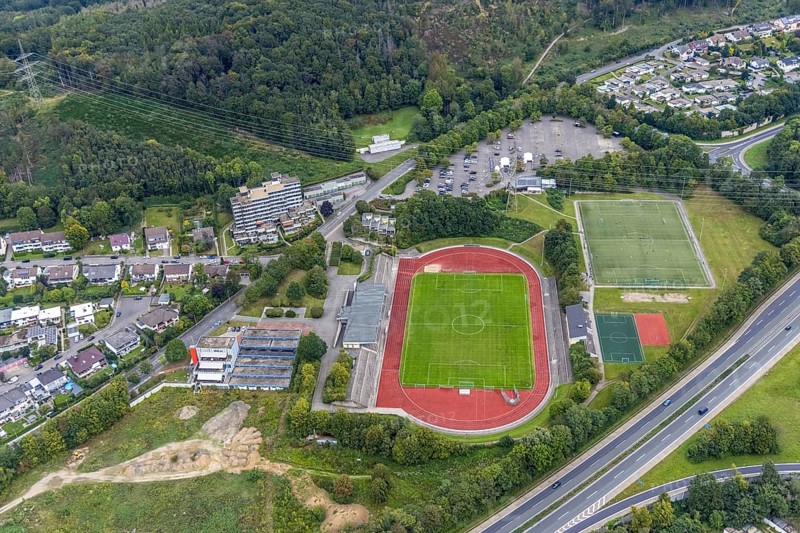 Aerial view, fallow land at the Kirchenbergstadion with planned construction of a fitness centre in the Hohenlimburg district, Hagen, Ruhr area, North Rhine-Westphalia, Germany, A46 motorway, construction area, building site, building plots, construction project, construction site, DE, Europe, football pitch, property tax, real estate, aerial view, aerial photography, aerial photography, sports, sports facilities, sports field, sports facility, overview, bird's eye view, residential complex, living and living, residential buildings, quality of living, birds-eyes view, overview