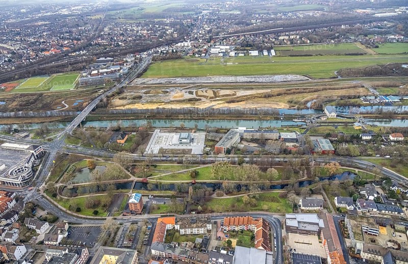 Aerial view construction area new water sports centre on Adenauerallee at Hammonense grammar school with transition to Nordring and Hans-Böckler-Platz in Hamm, Ruhr area, North Rhine-Westphalia, Germany, construction work, construction vehicles, construction area, construction site, building plots, construction crane, construction measure, construction project, construction site, education, educational institution, DE, Datteln-Hamm Canal, development, Europe, Hamm airfield, River Lippe, business park, grammar school, Hamm, industrial area, canal edge, educational institute, Lippe floodplain, aerial photograph, aerial photography, aerial photography, Rhine-Ruhr metropolitan region, new construction, shipping, Hamm lock, school, overview, bird's-eye view, overview