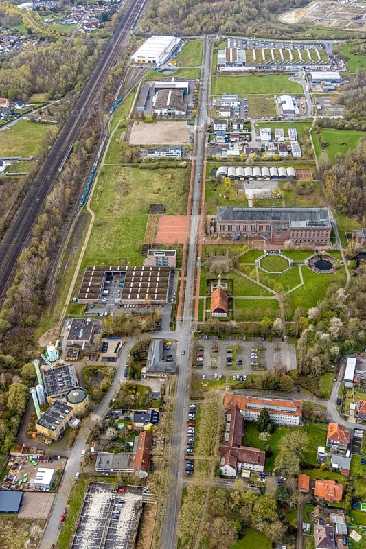 Aerial view, commercial area Ökozentrum Sachsenweg and Alfred-fisherman-Halle in Heessen, Hamm, Ruhr area, North Rhine-Westphalia, Germany, railway tracks, DE, Europe, commercial enterprises, commercial area, commercial park, commercial location, commercial use, industrial area, industrial building, industrial culture, industrial site, Keolis Deutschland GmbH, aerial view, aerial photography, aerial photography, SMT Scharf AG, Sondermann-Brot Bäckerei, overview, event location, event venue, event centre, bird's-eye view, forest area, birds-eyes view, overview, Öko-Zentrum North Rhine-Westphalia