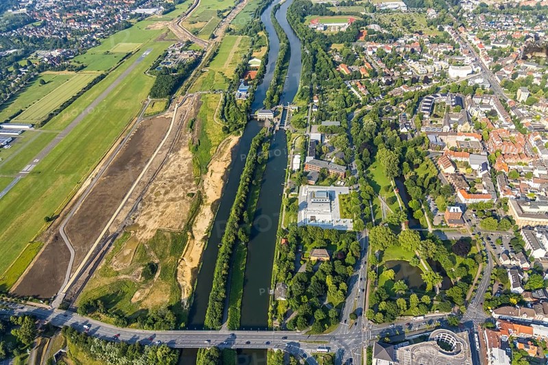 Aerial view, Hamm-Lippewiesen airfield, construction site for protective dam at Jupp-Eickhoff-Weg, Lippe beach, Lippe floodplain, Hamm lock, Lippe river, Datteln-Hamm canal, Hammonense grammar school, new water sports centre, Heessen, Hamm, Ruhr area, North Rhine-Westphalia, Germany, construction work, construction area, construction site, construction measure, construction project, construction site, education, educational institution, DE, Europe, flight emission, airport, aircraft noise, airfield, grammar school, sewage treatment plant Hamm Lippeverband, runway, educational institute, aerial photograph, aerial photography, aerial photography, North Rhine-Westphalia, school, runway, overview, bird's-eye view, overview