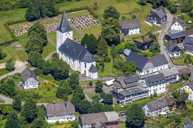 Aerial view, view of Schönholthausen, Kath. Pfarrkirche Mariä Himmelfahrt, Finnentrop, Sauerland, North Rhine-Westphalia, Germany, place of worship, burial place, DE, Europe, cemetery, memorial, religious community, place of worship, house of God, land tax, burial ground, holy place, real estate, church, parish, denomination, aerial view, aerial photography, aerial photography, religion, religious site, resting place, overview, bird's-eye view, housing estate, housing and living, residential area, residential buildings, housing quality, housing estate, birds-eyes view, overview