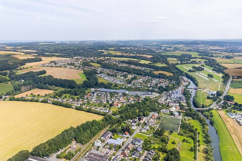 Aerial view, Schürenfeld planned industrial area at the federal road B233 Unnaer Straße in the district Dellwig, view to the district Langschede and Ardey, Wasserwerke Westfalen GmbH city limits Menden, Fröndenberg/Ruhr, Ruhr area, North Rhine-Westphalia, Germany, car repair shop, DE, Europe, commercial enterprises, commercial area, commercial area, commercial site, commercial use, industrial area, industrial building, industrial site, landscape conservation area, aerial view, aerial photography, aerial photography, Menden, nature reserve, nature reserve Strickherdicker Bachtal, overview, bird's-eye view, birds-eyes view, overview