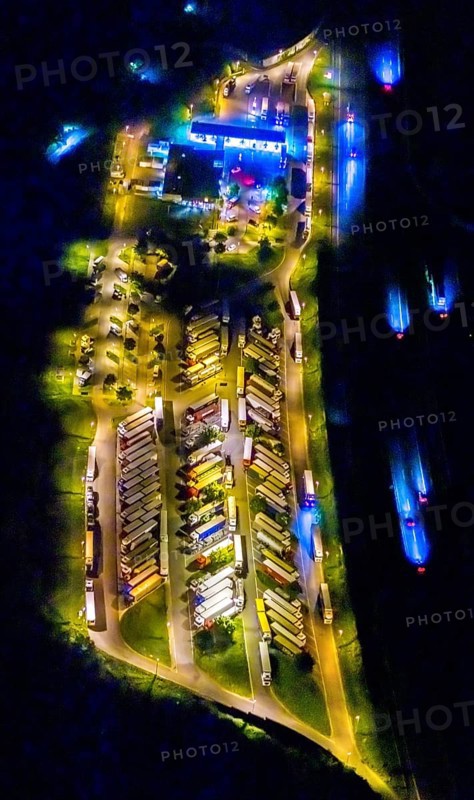 Aerial photo, motorway service area Resser Mark, Resse, Gelsenkirchen, Ruhr area, North Rhine-Westphalia, Germany, motorway A2, DE, twilight photography, Europe, shapes and colours, truck parking, tracers, light pollution, aerial photography, aerial photography, night, night photography, night flight, parking, road traffic, overview, bird's eye view, illuminated road traffic, birds-eyes view, nightflight, overview