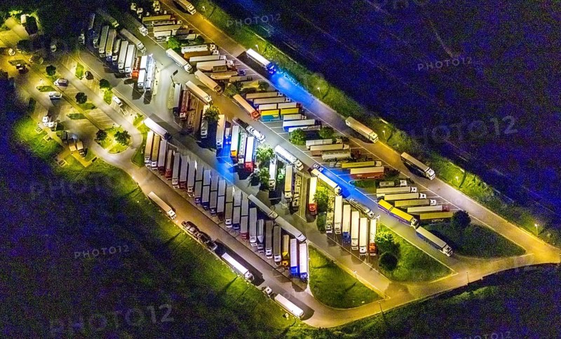 Aerial view, motorway service area Resser Mark, Resse, Gelsenkirchen, Ruhr area, North Rhine-Westphalia, Germany, motorway A2, DE, twilight photography, Europe, shapes and colours, truck parking, light pollution, aerial photography, aerial photography, night, night photography, night flight, parking, road traffic, overview, bird's eye view, illuminated road traffic, birds-eyes view, nightflight, overview