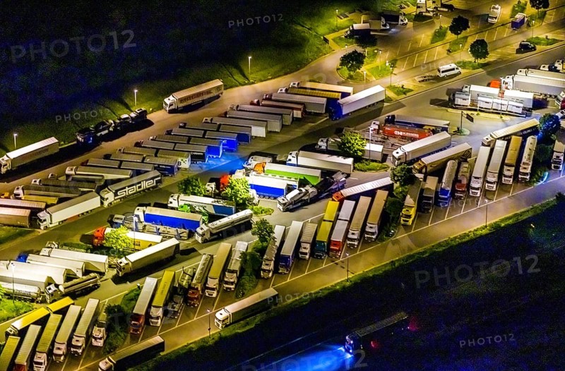 Aerial view, motorway service area Resser Mark, Resse, Gelsenkirchen, Ruhr area, North Rhine-Westphalia, Germany, motorway A2, DE, twilight photography, Europe, shapes and colours, truck parking, light pollution, aerial photography, aerial photography, night, night photography, night flight, parking, road traffic, overview, bird's eye view, illuminated road traffic, birds-eyes view, nightflight, overview