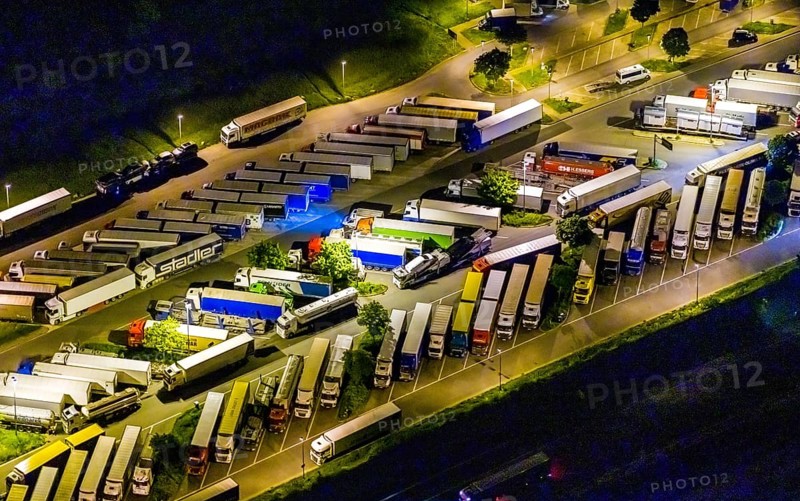 Aerial view, motorway service area Resser Mark, Resse, Gelsenkirchen, Ruhr area, North Rhine-Westphalia, Germany, motorway A2, DE, twilight photography, Europe, shapes and colours, truck parking, light pollution, aerial photography, aerial photography, night, night photography, night flight, parking, road traffic, overview, bird's eye view, illuminated road traffic, birds-eyes view, nightflight, overview