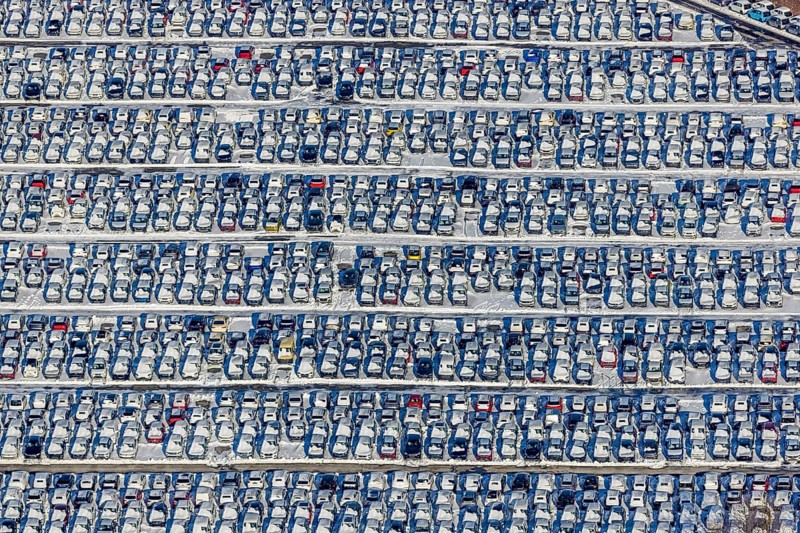 Aerial photo, CAT Automobillogistik Essen, Essen-Altenessen, Essen, Ruhr area, North Rhine-Westphalia, Germany, DE, Europe, shapes and colours, storage, logistics, logistics service, logistics service provider, logistics provider, aerial photo, aerial photography, aerial photography, snow, transport, transport service, overview, bird's eye view, winter, birds-eyes view, overview, car dump in winter, rows of cars, different coloured cars, car lot