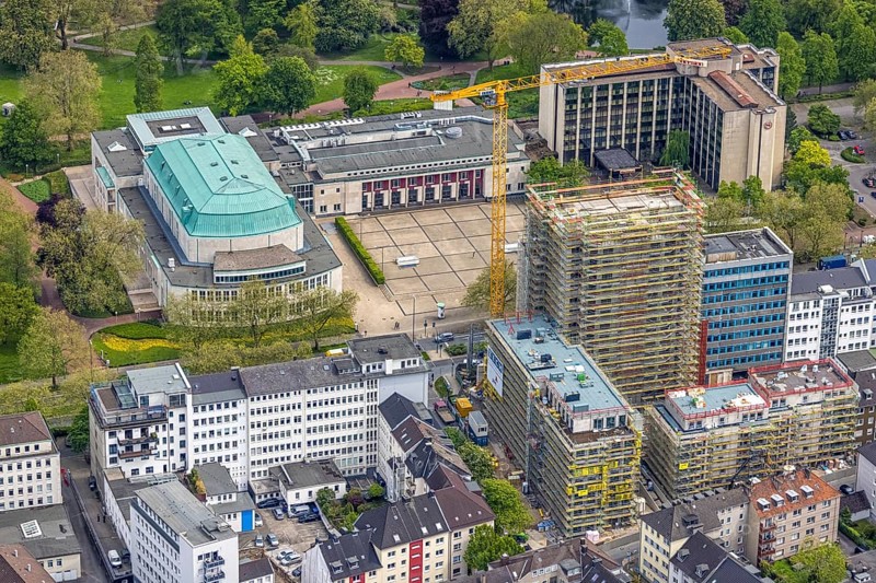 Aerial view, Philharmonie Essen on Huyssenallee, construction site, new building complex with residential tower and senior citizens' flats Huyssenallee, Essen, Ruhr area, North Rhine-Westphalia, Germany, construction work, construction, construction area, construction site, construction crane, construction measure, construction project, construction site, care and nursing, DE, renewal, development, Europe, catering, hotel, hotel facilities, hotel industry, capacity requirements, concert hall, culture, art, aerial photography, aerial photography, aerial photography, new building, care facility, retirement home, retirement centre, Sheraton Essen Hotel, overview, events, venue, event location, event centre, bird's eye view, birds-eyes view, cultural use, overview