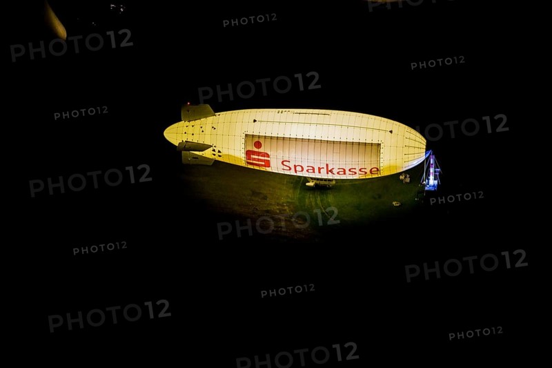 Aerial photograph, Sparkasse airship, airfield Essen Mülheim, Haarzopf, Essen, Ruhr area, North Rhine-Westphalia, Germany, outdoor lighting, DE, twilight, Europe, flying objects, light pollution, aerial photograph, aerial photography, aviation, aerial photography, airship, Mülheim an der Ruhr, night aerial photograph, streetlights, street lamps, overview, bird's eye view, zeppelin, illuminated, illuminated houses, illuminated house, birds-eyes view, artificial light, night, nightflight, overview