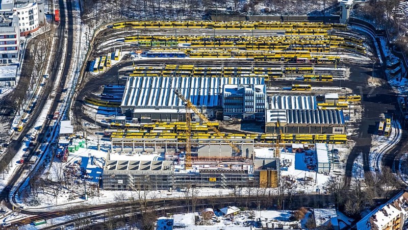 Aerial view, construction site, new hall construction Ruhrbahn depot, city centre, Essen, Ruhr area, North Rhine-Westphalia, Germany, construction work, construction area, construction site, building plots, construction project, construction site, bus station, DE, Europe, aerial view, aerial photography, aerial photography, new building, snow, tramway, overview, bird's eye view, winter, birds-eyes view, overview