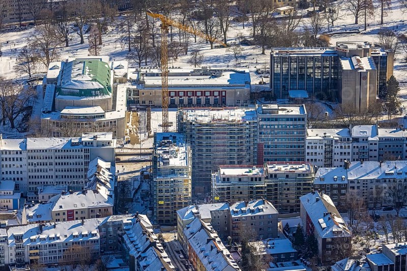 Aerial view, Philharmonie Essen, Sheraton Essen Hotel, construction site, new building complex with residential tower and senior flats, Huyssenallee, Essen-Holsterhausen, Essen, Ruhr area, North Rhine-Westphalia, Germany, construction work, construction area, construction site, building plots, construction measure, construction project, construction site, DE, Europe, gastronomy, hotel, hotel facilities, hotel industry, culture, art, aerial view, aerial photography, aerial photography, new building, snow, overview, events, bird's eye view, winter, birds-eyes view, overview