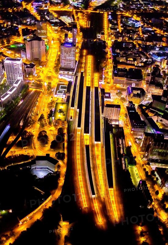 Aerial view, Essen central station, eastern district, Essen, Ruhr area, North Rhine-Westphalia, Germany, outdoor lighting, railway station, DE, Deutsche Bahn AG, twilight, Europe, commercial buildings, central station, main station, light pollution, aerial photograph, aerial photography, aerial photography, night aerial photograph, streetlights, street lamps, overview, bird's eye view, illuminated, illuminated houses, illuminated house, birds-eyes view, artificial light, night, nightflight, overview