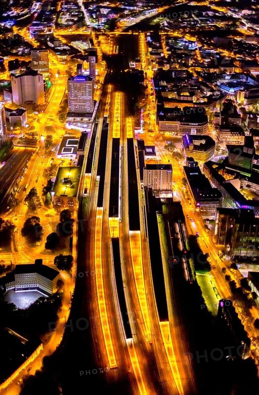 Aerial view, Essen central station, south-east quarter, Essen, Ruhr area, North Rhine-Westphalia, Germany, outdoor lighting, railway station, DE, Deutsche Bahn AG, twilight, Europe, commercial buildings, central station, main station, light pollution, aerial photograph, aerial photography, aerial photography, night aerial photograph, streetlights, street lamps, overview, bird's eye view, illuminated, illuminated houses, illuminated house, birds-eyes view, artificial light, night, nightflight, overview