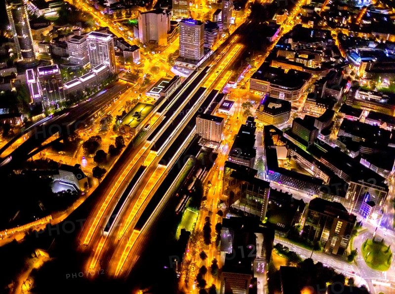 Aerial view, Essen central station, south-east quarter, Essen, Ruhr area, North Rhine-Westphalia, Germany, outdoor lighting, railway station, DE, Deutsche Bahn AG, twilight, Europe, commercial buildings, central station, main station, light pollution, aerial photograph, aerial photography, aerial photography, night aerial photograph, streetlights, street lamps, overview, bird's eye view, illuminated, illuminated houses, illuminated house, birds-eyes view, artificial light, night, nightflight, overview