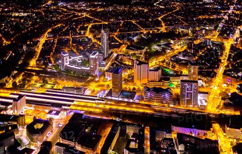 Aerial view, Essen central station, business district, Westenergie tower, demolition Ypsilon-Haus, Essen-Holsterhausen, Essen, Ruhr area, North Rhine-Westphalia, Germany, outdoor lighting, railway station, construction work, construction site, building site, construction project, construction site, DE, Deutsche Bahn AG, twilight, Europe, commercial buildings, central station, main station, light pollution, aerial view, aerial photography, aerial photography, night aerial photography, streetlights, street lamps, tower, overview, bird's eye view, illuminated, illuminated houses, illuminated house, birds-eyes view, artificial light, night, nightflight, overview