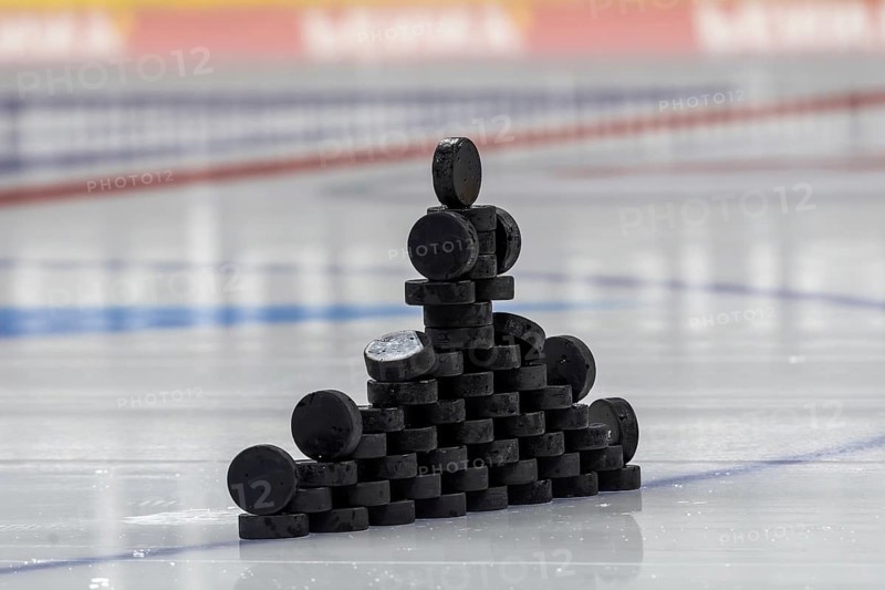 Symbolic picture DEL (German Ice Hockey League) : Close-up of pucks stacked on the ice for play-in