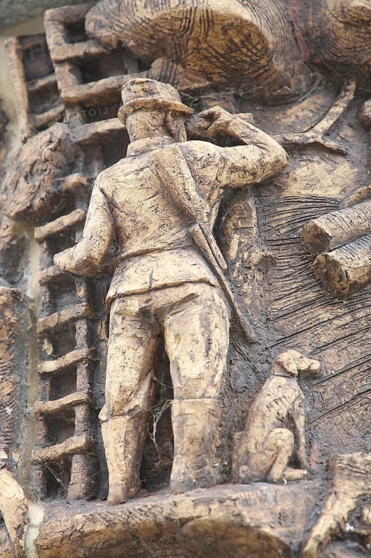 Relief on the market fountain, sculpture, hunter with shotgun watching with binoculars, hunting, dog figure, leader, symbol, market square, Haldensleben, Saxony-Anhalt, Germany