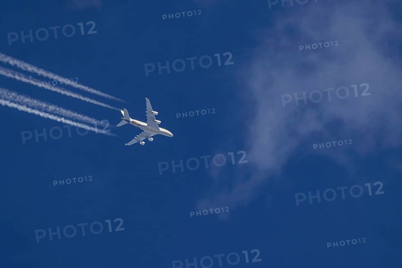 Aircraft in the sky at cruising altitude. Airbus A380 of the airline Ethihad en route to Abu Dhabi. Contrails in the sky. These artificial clouds are created from the exhaust fumes of aeroplanes. But there are also conspiracy theory myths. Stuttgart, Baden-Württemberg, Germany