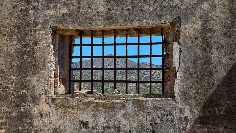 View through a barred window onto a mountain landscape, Old Silk Factory, German Wehrmacht military prison, Concentration Camp, Lost Place, Kattavia, Rhodes, Dodecanese, Greek Islands, Greece