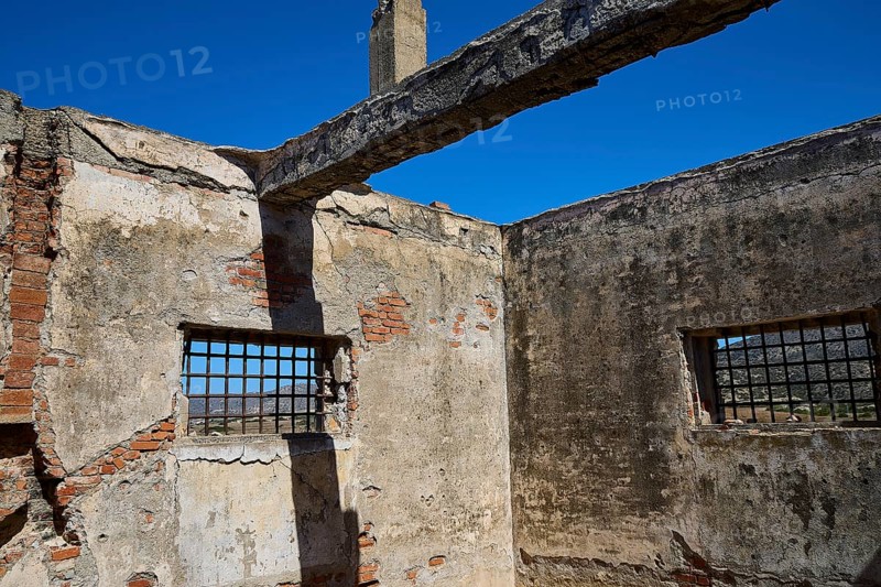 Interior view of a dilapidated building with rustic bricks and lattice windows, Old silk factory, German Wehrmacht military prison, concentration camp, Lost Place, Kattavia, Rhodes, Dodecanese, Greek Islands, Greece