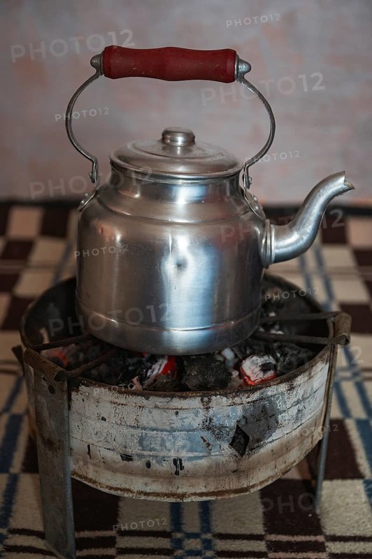 Olodschool kettle on the stove with fire charcoal