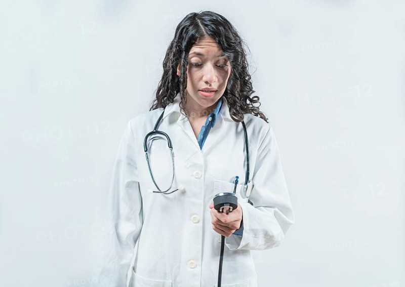 Surprised doctor with blood pressure monitor. Surprised female doctor with blood pressure monitor isolated