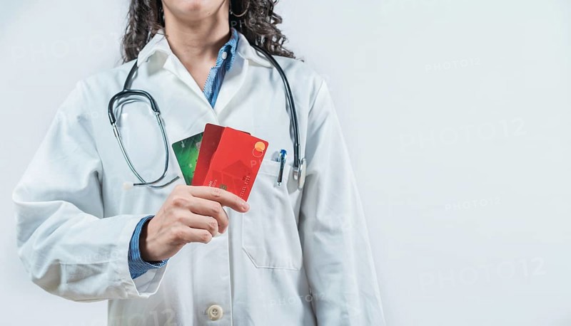 Doctor holding credit cards isolated. Unrecognizable doctor with credit cards, medical payment concept