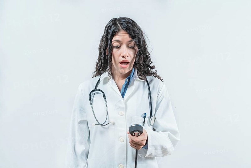 Surprised female doctor with blood pressure monitor isolated. Surprised doctor with blood pressure monitor
