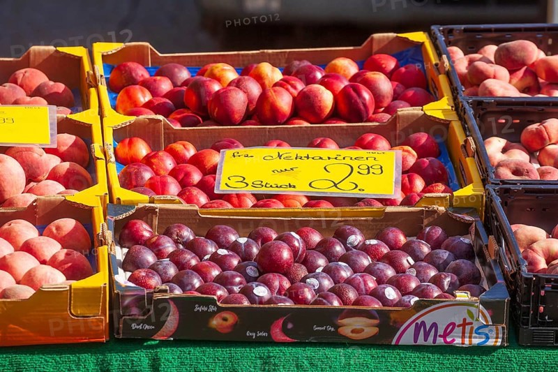 Necatarines and fresh fruit in crates with price tags on a market stall, Bremen, Germany