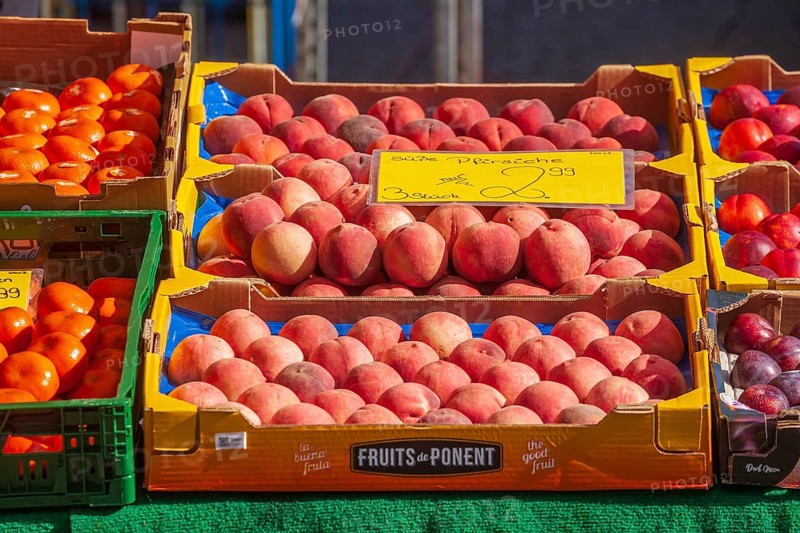 Necatarines and fresh fruit in crates with price tags on a market stall, Bremen, Germany