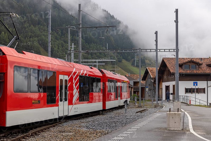 Metre-gauge electric low-floor multiple-unit trains of the Matterhorn-Gotthard Railway (MGB) ORION (Optimaler Regionalzug Im Oeffentlichen Nahverkehr) from Stadler, Sedrun station, Surselva, Grisons, Switzerland