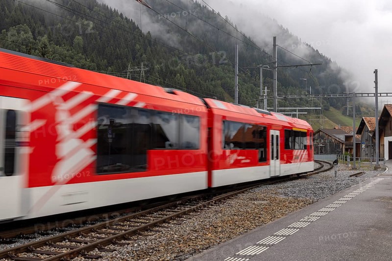 Metre-gauge electric low-floor multiple-unit trains of the Matterhorn-Gotthard Railway (MGB) ORION (Optimaler Regionalzug Im Oeffentlichen Nahverkehr) from Stadler, Sedrun station, Surselva, Grisons, Switzerland