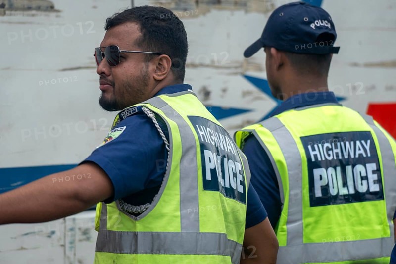 Two highway police officers in reflective vests coordinating together, Dhaka, Bangladesh