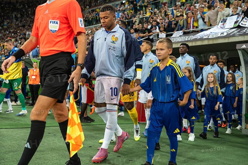 WROCLAW, POLAND - SEPTEMBER 5, 2025: Qualifications for FIFA 2026. Football match Ukraine vs France 0:2. Captain Mbappe Kylian with boy and team of France before the game