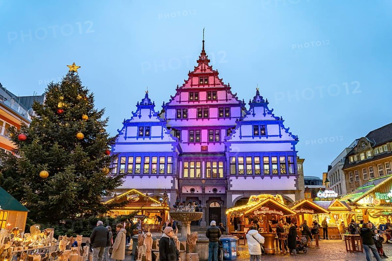 Christmas market at the colourfully illuminated Paderborn Town Hall at duskin Paderborn, North Rhine-Westphalia, Germany