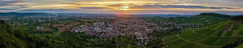 Vineyards and town in front of an impressive sunset under a dramatic sky, Korb im Remstal, Baden-Württemberg, Germany