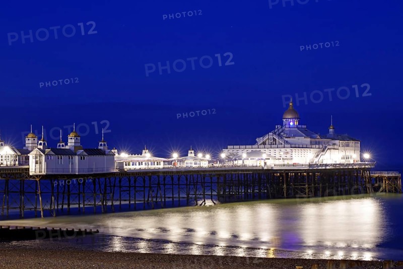 Illuminated pier at night with reflecting lights in the water, Victorian, Bournemouth, England, Great Britain