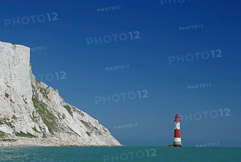 Red lighthouse in front of white cliffs at the blue sea, Old Harrys Rock, Beachy Head Lighthouse, Bournemouth, Dorset, England, Great Britain