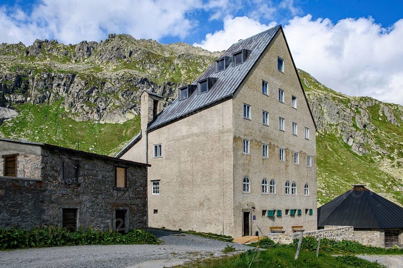 View of building Ospizio Hospiz Herberge San Gottardo St. Gotthard built from 1230 in the 13th century with small entrance door main entrance on pass summit of Gotthard Pass, Swiss Alps, Airolo, Canton Ticino, Ticino, Switzerland
