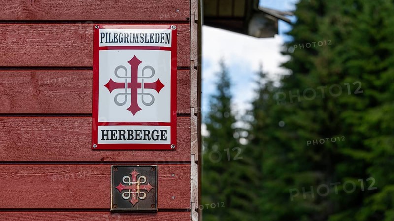 Waymarker Olav's Cross for pilgrims, pilgrims' hostel in the forest, near Eidsvoll, Norway