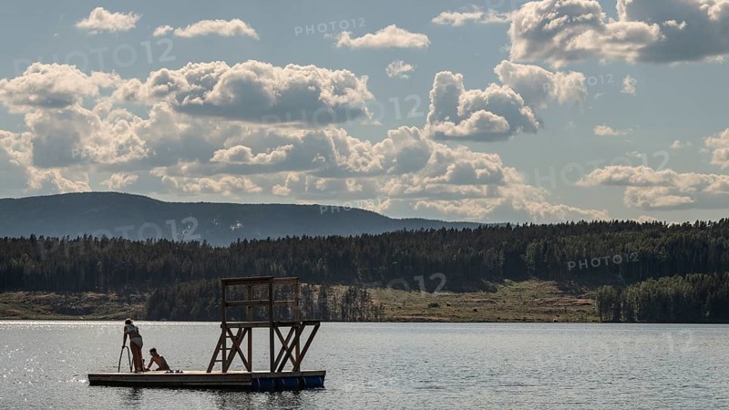 Children playing on a platform at a bathing place at Lake Mjøsa or Mjosa with wooded shore, Olavsweg or Olavsleden, near Tangen, Norway