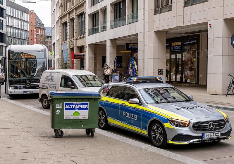 Bus and police vehicle in Großer Burstah, Hamburg, Germany