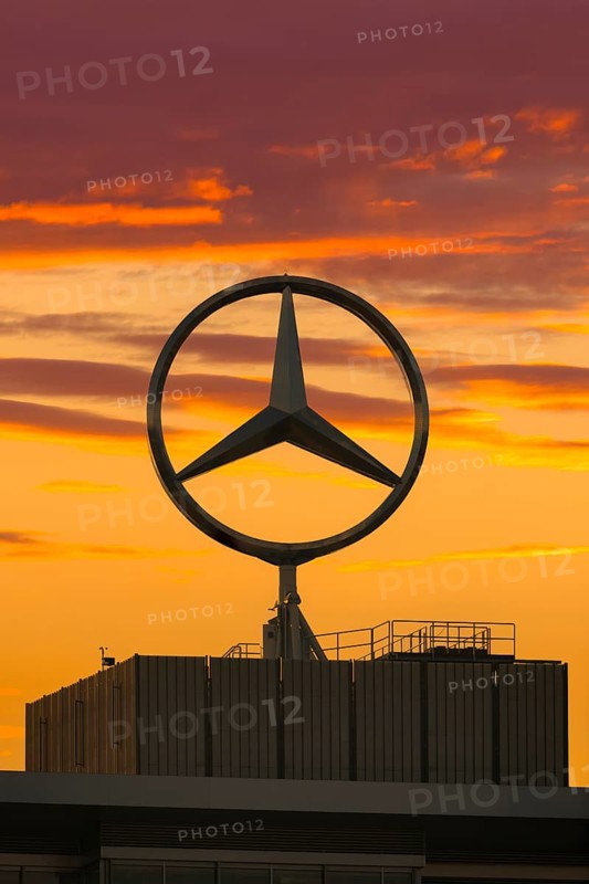 Large Mercedes-Benz logo in front of a dramatic sunset, Stuttgart, Baden-Württembwerg, Germany