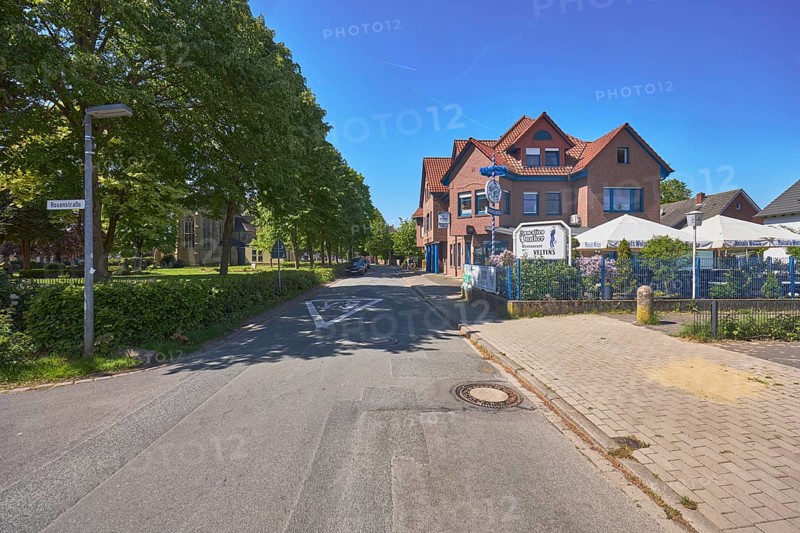 Restaurant Zum alten Pauker, clinker brick building, general development, historic cemetery, trees, lawn, street, blue sky, cloudless, intersection Alte Schulstraße with Rosenstraße, Alfhausen, district of Osnabrück, Lower Saxony, Germany